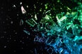 Brightly colored pieces of glass shattering against a black background, creating a vibrant and chaotic visual effect Royalty Free Stock Photo