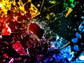 Brightly colored pieces of glass shattering against a black background, creating a vibrant and chaotic visual effect Royalty Free Stock Photo