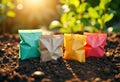 Colorful seed packets placed on soil with sunlight and greenery in the Royalty Free Stock Photo