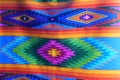 Brightly colored traditional fabric for sale at Otavalo market in Ecuador. South American native woven fabric