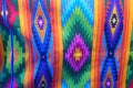 Brightly colored traditional fabric for sale at Otavalo market in Ecuador. South American native woven fabric