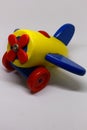 Brightly colored wooden toy plane isolated on a white background Royalty Free Stock Photo