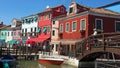 Brightly coloured/colored houses, by a canal, on Burano Island, Venice, Italy