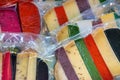 Brightly coloured favored cheese wrapped for sale at a market