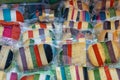 Brightly coloured favored cheese wrapped for sale at a market