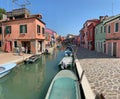 Brightly coloured houses along the channel at Burano, island in the Venetian Lagoon, Venice, Italy