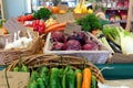 Brightly coloured selection of healthy organic vegetables in wicker baskets, including chilli, garlic, red onion,pepper, tomato