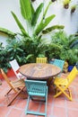 Brightly coloured wooden chairs and table in garden