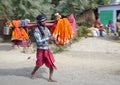 Brightly dressed religious pilgrims walk alongside the road in rural India.