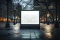 Brightly lit blank billboard stands out from the downtown area around at the early evening hours. Good as copy space for