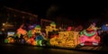 A brightly lit Christmas parade with colorful floats musi generative AI