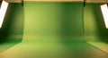 Brightly Lit Green Screen Studio with Seamless Chroma Key Backdrop and Dual Softbox Lights Royalty Free Stock Photo
