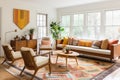 a brightly lit living room with vintage teak furniture and geometric rug