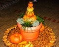 Brightly lit pumpkin pyramid in flowerpot Royalty Free Stock Photo