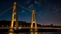 A brightly lit suspension bridge glowing against a night sky Royalty Free Stock Photo
