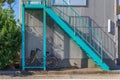 Brightly painted metal staircase with bicycle.