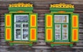 Brightly painted wooden windows on a log house