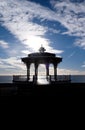 Brighton Band silhoutted by sun dramatic sky