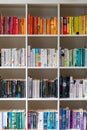 White wooden bookcase filled with books in a UK home Royalty Free Stock Photo
