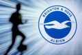 BRIGHTON, ENGLAND, JULY. 1. 2019: Brighton Hove Albion Football club logo, Premier League, England. Soccer player silhouette Royalty Free Stock Photo