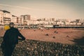 Brighton, England - October 19: Beautiful view of Brighton Pier with Brighton beach sea, sand and backside man of local people.