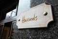 Brighton, England-18 October,2018: The famous place for shopping Harrods Department Store with the name in Golden sign on white