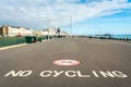 Brighton, England-18 October,2018: No cycling sign on footpath or sidewalk in public area at Brighton Pier with local, group