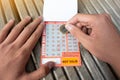 Student or tourism scratching seven day bus pass ticket for public bus in Brighton & Hove route. Royalty Free Stock Photo