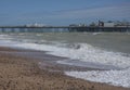 Brighton, England, the UK - a sunny day on the beach, a pier. Royalty Free Stock Photo