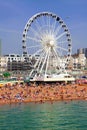 BRIGHTON -JULY 14,2013 - View the golden sand of Brighton beachfront to the ferris wheel and amusement park with groups of people