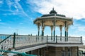 Brighton Pier Beach with Victorian bandstand octagonal pavilion Chinese and Indian style in the background Royalty Free Stock Photo