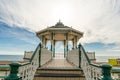 Brighton Pier Beach with Victorian bandstand octagonal pavilion Chinese and Indian style in the background Royalty Free Stock Photo