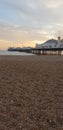 Brighton pier sunset busy Christmas beach pebbles Royalty Free Stock Photo