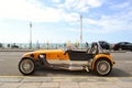 Lotus Cobra car parked in the Brighton beach avenue with old West Pier in background. Royalty Free Stock Photo