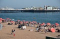 Crowd of British people sunbathing swimming and relaxing in the beach at summer. Leisure time outdoor