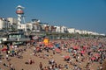 Crowd of British people sunbathing swimming and relaxing in the beach at summer. Leisure time outdoor