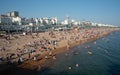 Crowd of British people sunbathing swimming and relaxing in the beach at summer. Leisure time outdoor