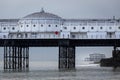 Brighton west pier seen through the legs of the palace pier