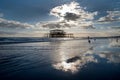 Brighton west Pier at sunset with a solitary man walking into the sea Royalty Free Stock Photo