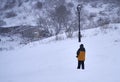 Brihuega, Spain - January 9, 2021: A lonely man observes the fallen snow after the Filomena snowstorm in the town of Brihuega