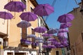 BRIHUEGA, SPAIN - JULY 10, 2021: Bright purple umbrellas hanging above the street during lavender fields blooming period, Brihuega