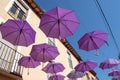 BRIHUEGA, SPAIN - JULY 10, 2021: Lavender colored umbrellas hanging above the street during fields blooming period, Brihuega,