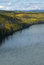 Brilliant autumn colors line the powerful Liard River