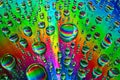 Brilliant burst of rainbow colors in water drops in abstract background asset