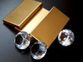 Brilliant diamond and gold bullion on a black background in a crisp plan Royalty Free Stock Photo