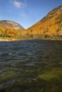 Brilliant fall foliage at Saco Lake in the White Mountains. Royalty Free Stock Photo
