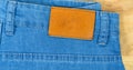 Brilliant leather blank on the back of blue jeans, Brown label on the waistband of jeans for wearing letters, denim backgrounds Royalty Free Stock Photo