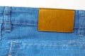 Brilliant leather blank on the back of blue jeans, Brown label on the waistband of jeans for wearing letters, denim backgrounds Royalty Free Stock Photo