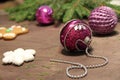 A brilliant lilac New Years ball close up. Spruce needles and branches.