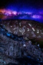 The brilliant Milky Way starry sky shining over the devastated rocky terrain. Royalty Free Stock Photo